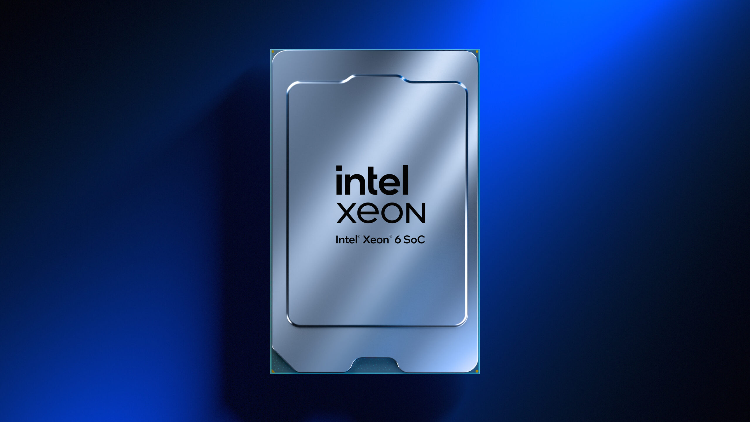 An Intel Xeon 6 SoC processor in a sleek metallic casing is displayed against a glossy blue background. The Intel Xeon logo is prominently featured at the center of the processor.